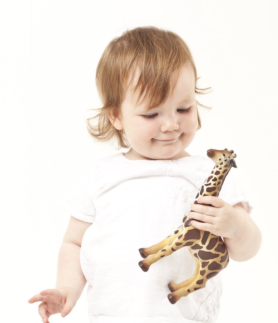 Toddler with educational toy Giraffe by green rubber toys 