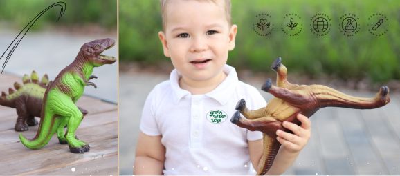 Boy holding dinosaur green rubber toys